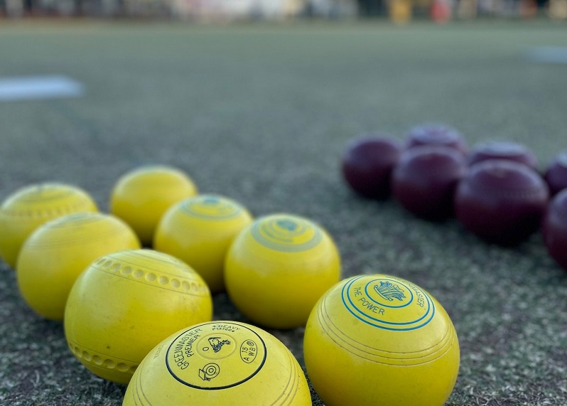 Yellow bowls on the greens of Northmead Bowling, Recreation and Sporting Club